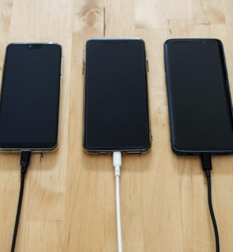 black android smartphones on brown wooden surface