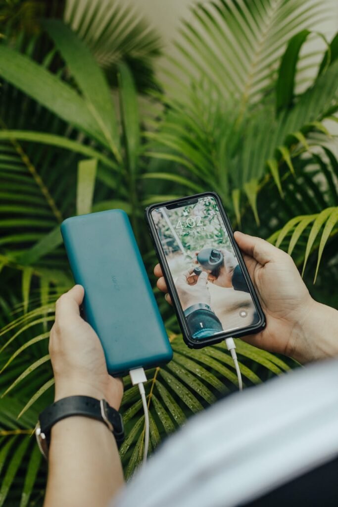 faceless person transferring data from smartphone to hard drive